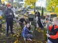 Dzieci sprzątają cmentarze
